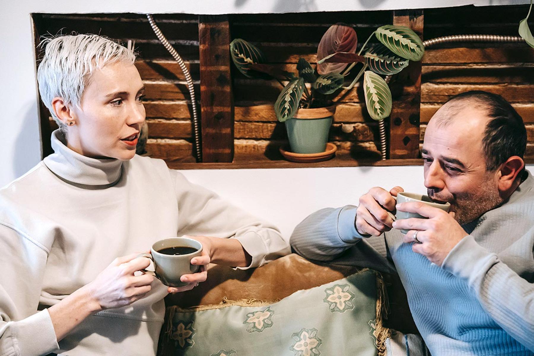Woman and man in discussions over coffee