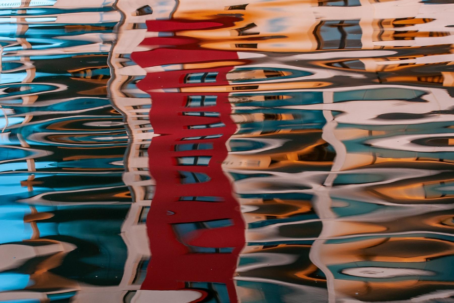 a water reflection of a colourful street