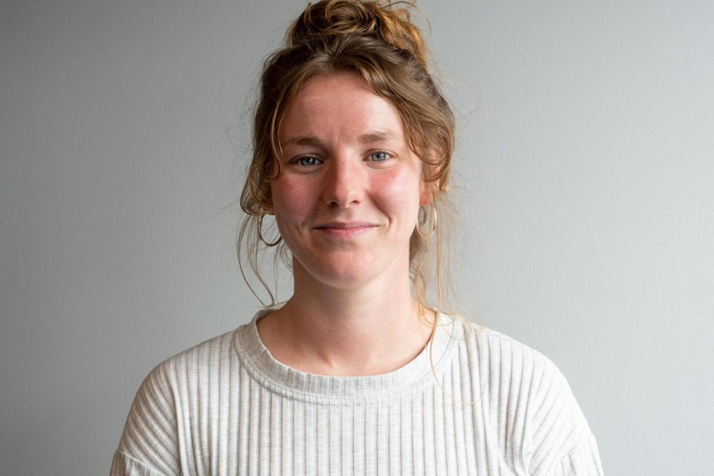 Hannah Martin smiling, hair in a loose bun