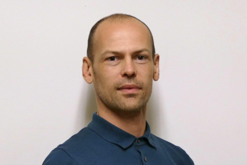 Stuart Muirhead in a dark blue polo shirt